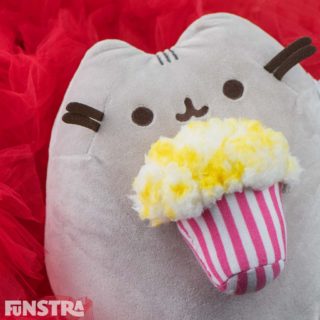 Pusheen plush enjoying an overflowing bucket of buttered popcorn. From the Pusheen Snackable collection, that features a cookie, ice cream, sushi, and more!